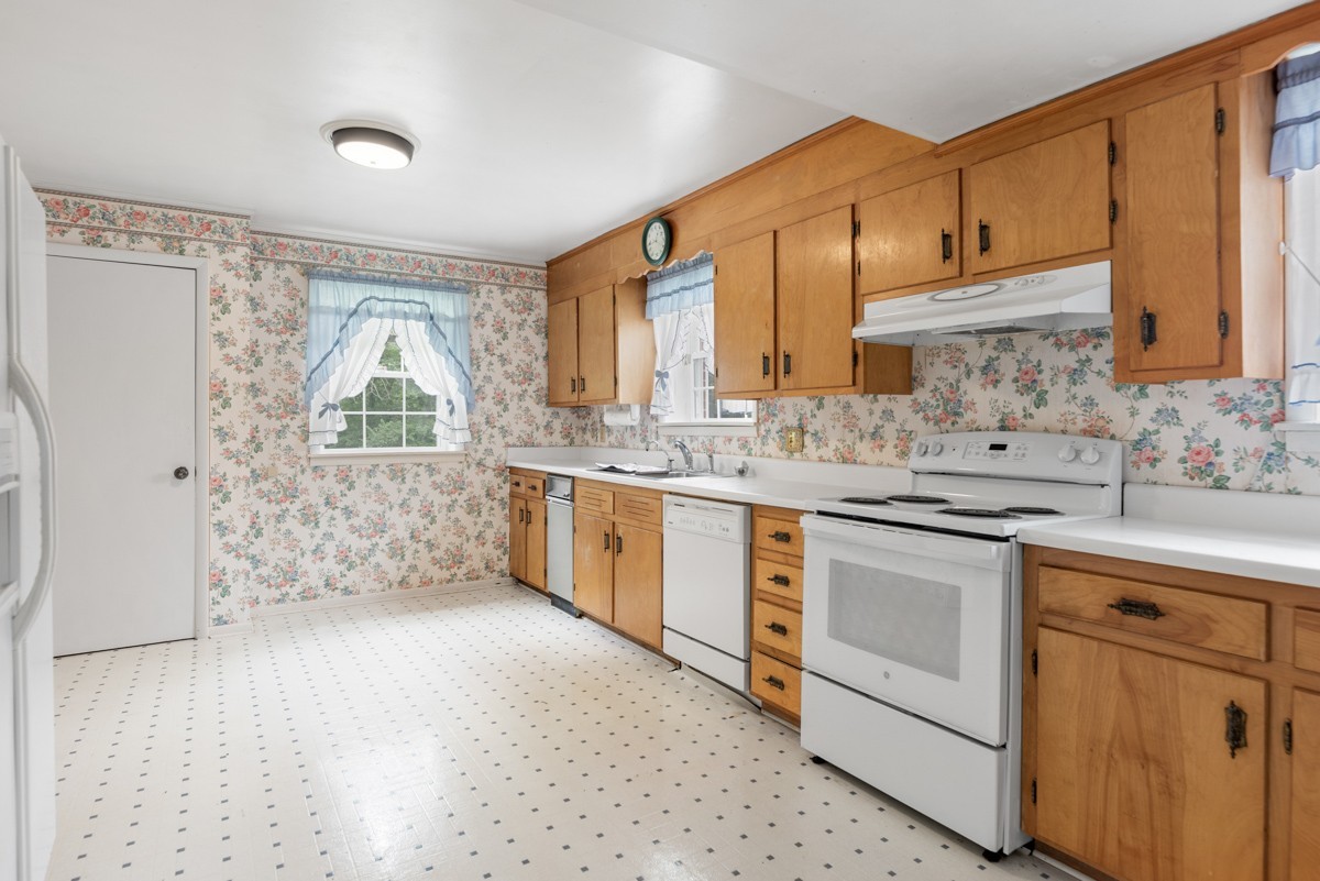 6908 River Rd Pike Nashville, TN 37209 - Photo 33 of 47 a kitchen with stainless steel appliances granite countertop a sink stove and cabinets