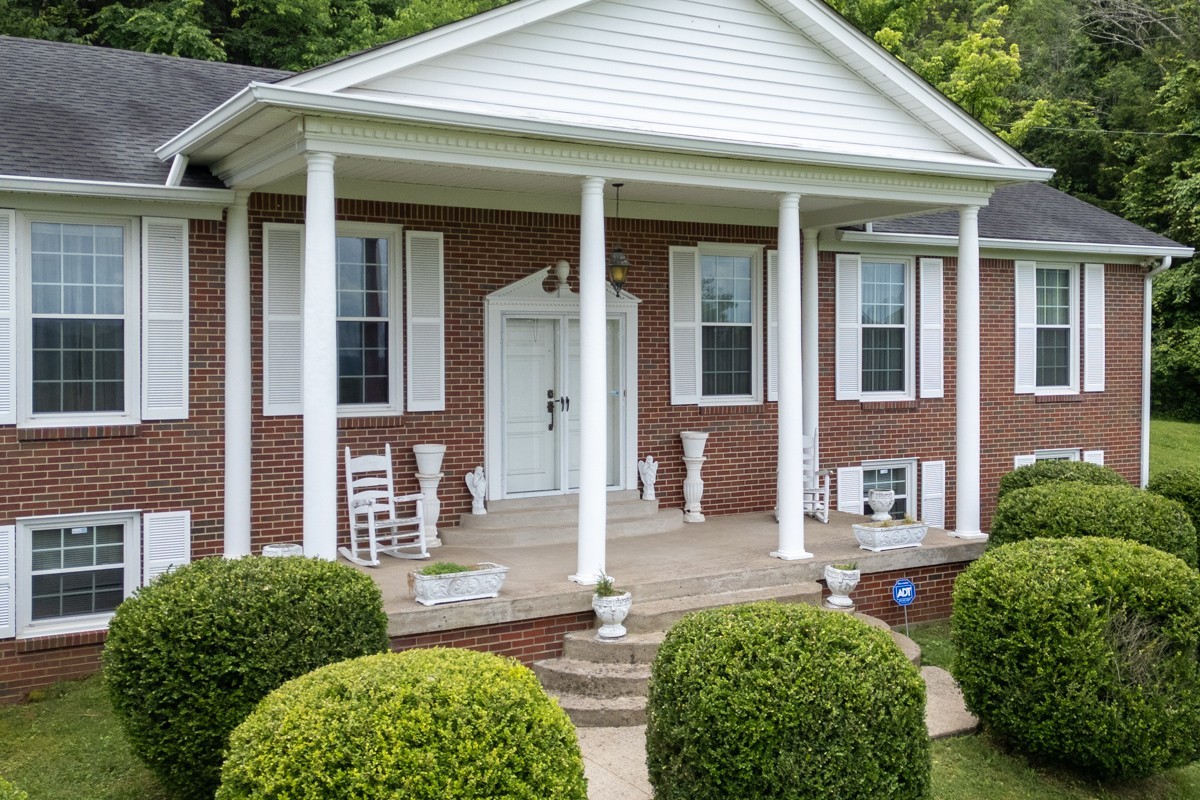 6908 River Rd Pike Nashville, TN 37209 - Photo 5 of 47 a front view of a house with garden