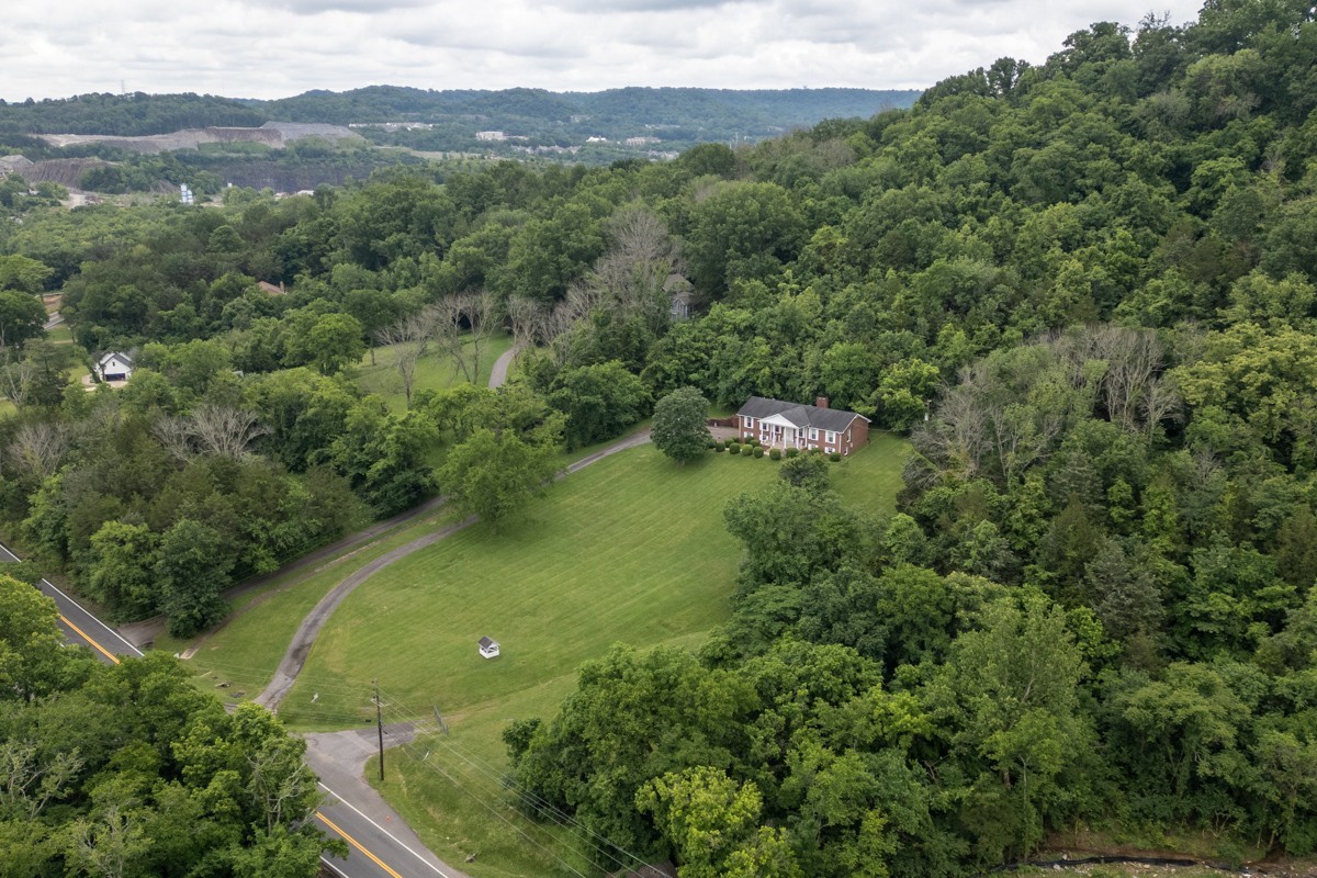 6908 River Rd Pike Nashville, TN 37209 - Photo 7 of 47 an aerial view of green landscape with trees houses and mountain view