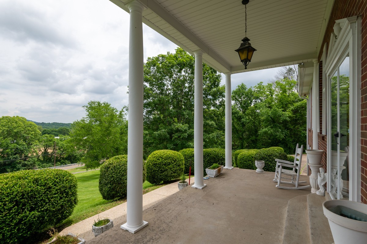 6908 River Rd Pike Nashville, TN 37209 - Photo 9 of 47 a view of a porch with furniture and garden