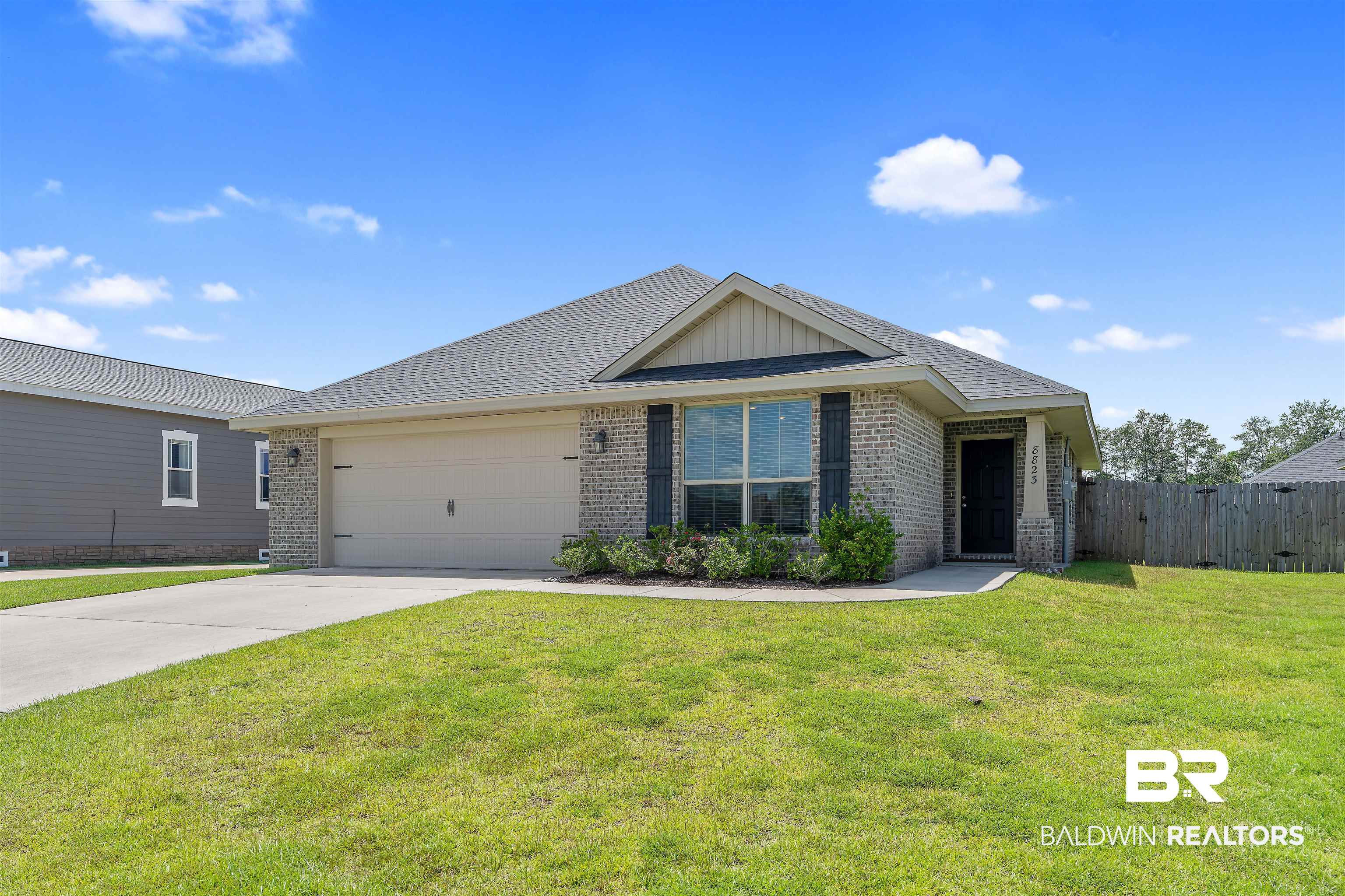 8823 Allay Lane Foley, AL 36535 - Photo 1 of 18 View of front of home featuring a garage and a front lawn