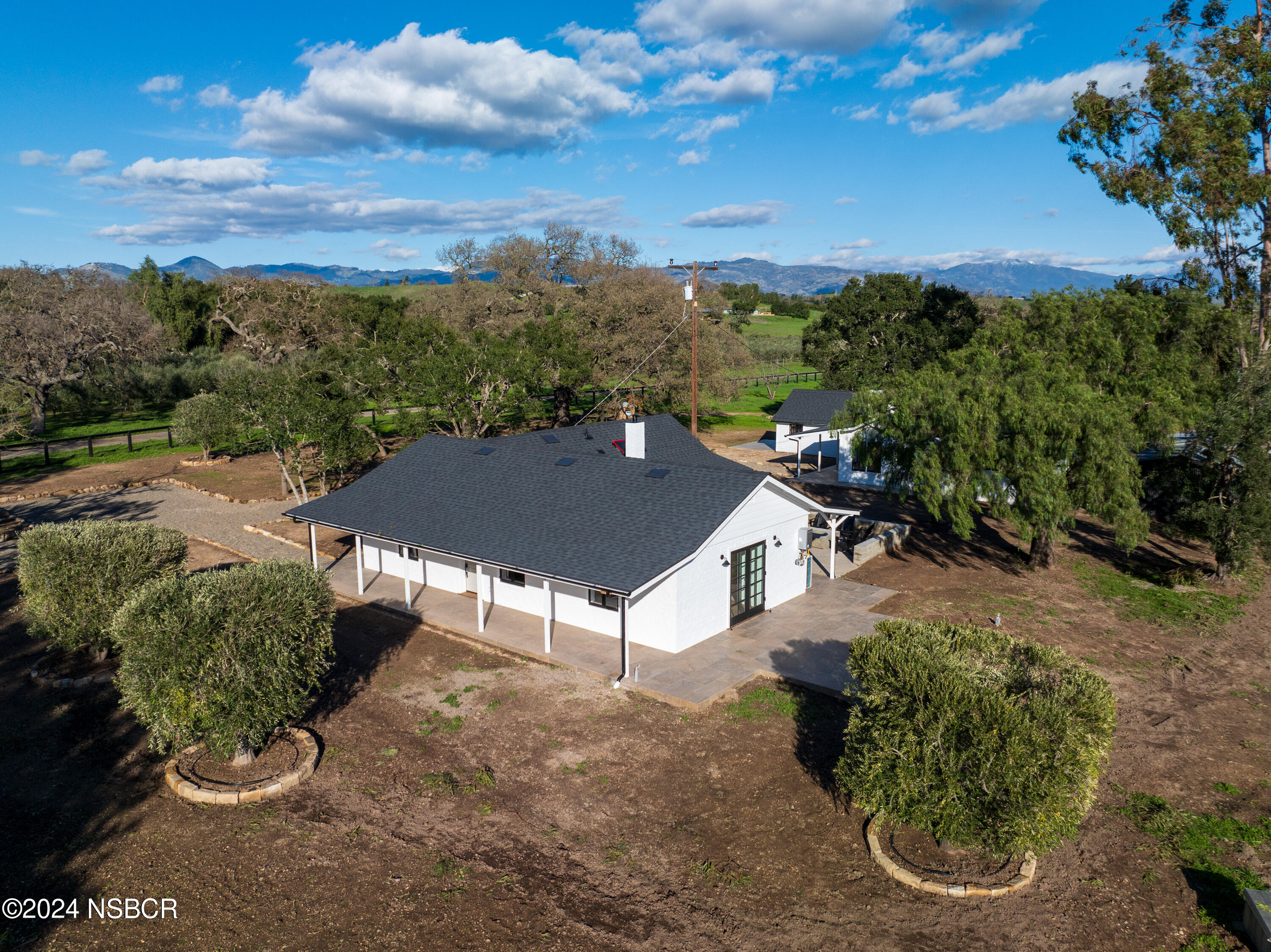 2380 North Refugio Road Santa Ynez, CA 93460 - Photo 1 of 38 a view of a house with a yard and potted plants