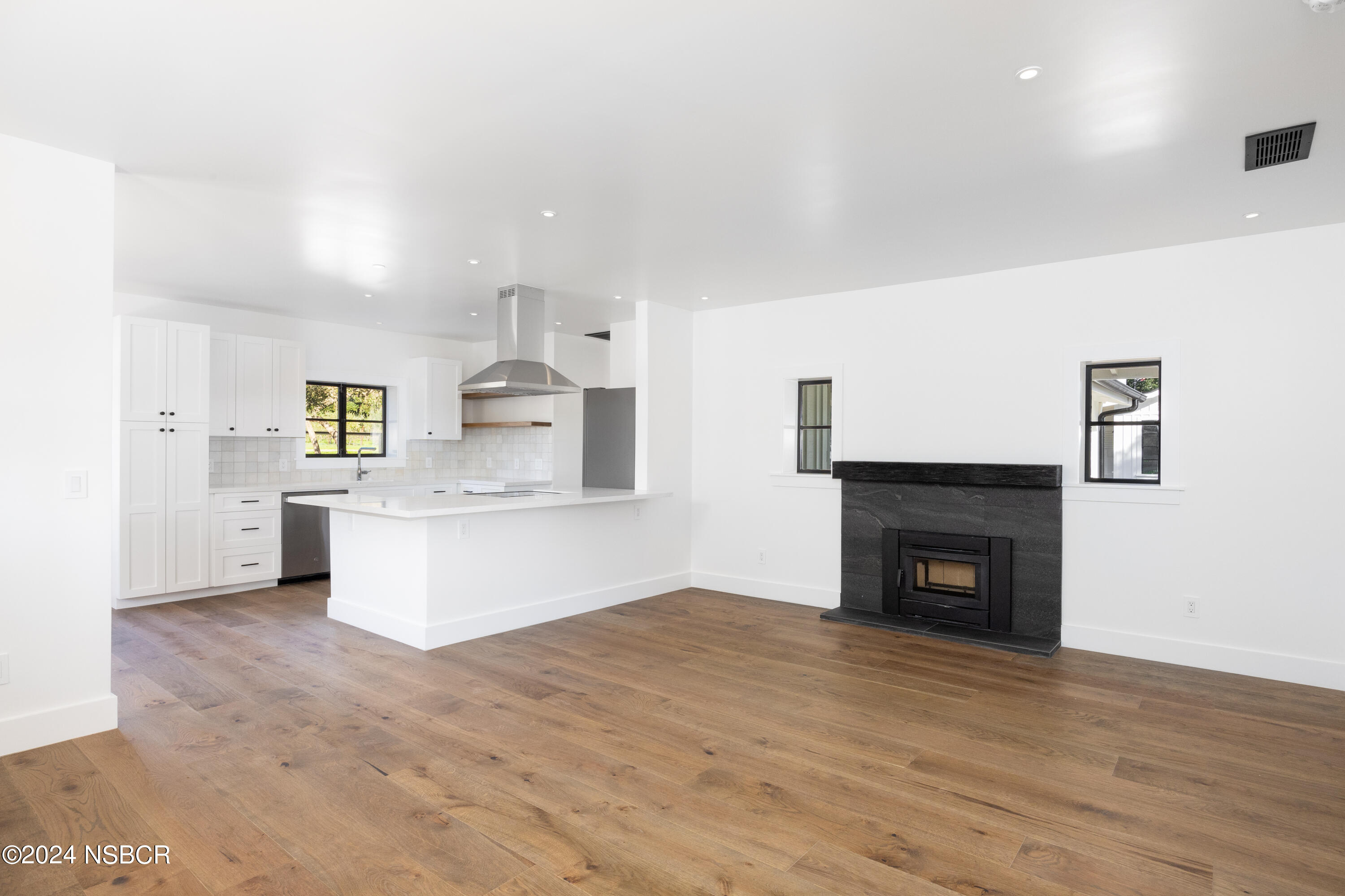 2380 North Refugio Road Santa Ynez, CA 93460 - Photo 12 of 38 a view of kitchen and empty room with wooden floor