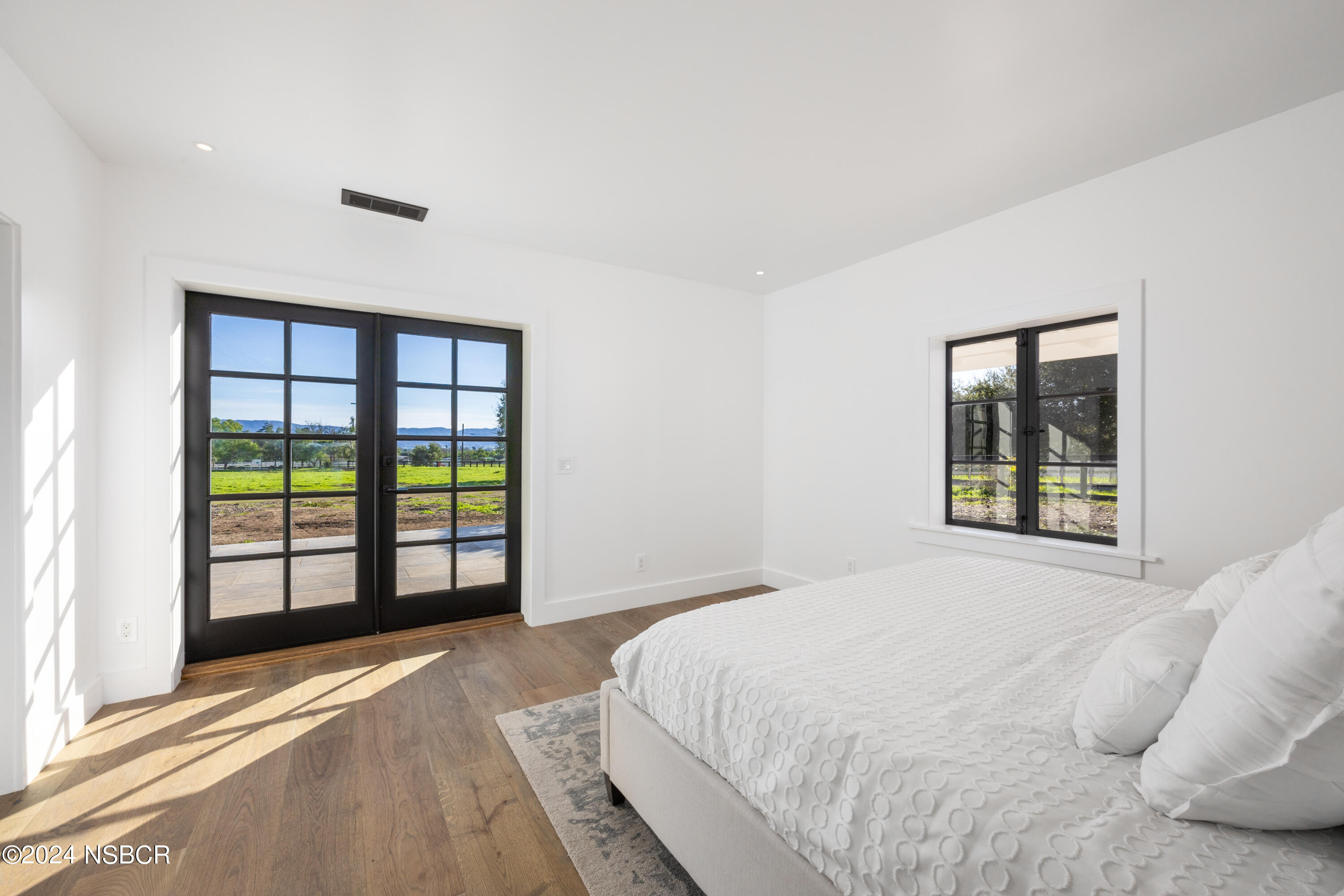 2380 North Refugio Road Santa Ynez, CA 93460 - Photo 16 of 38 a spacious bedroom with a bed and a window