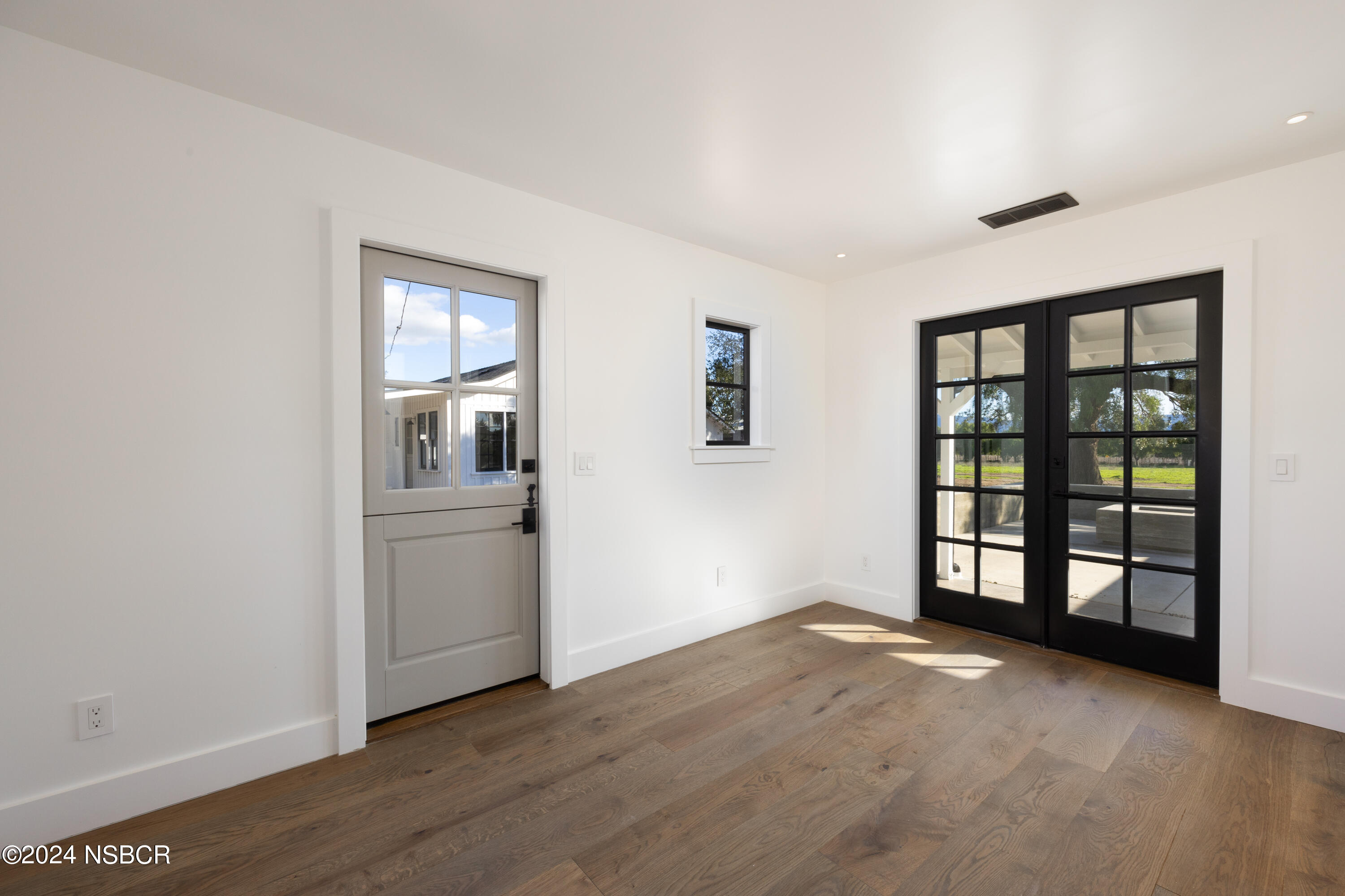 2380 North Refugio Road Santa Ynez, CA 93460 - Photo 24 of 38 wooden floor in an empty room with a window