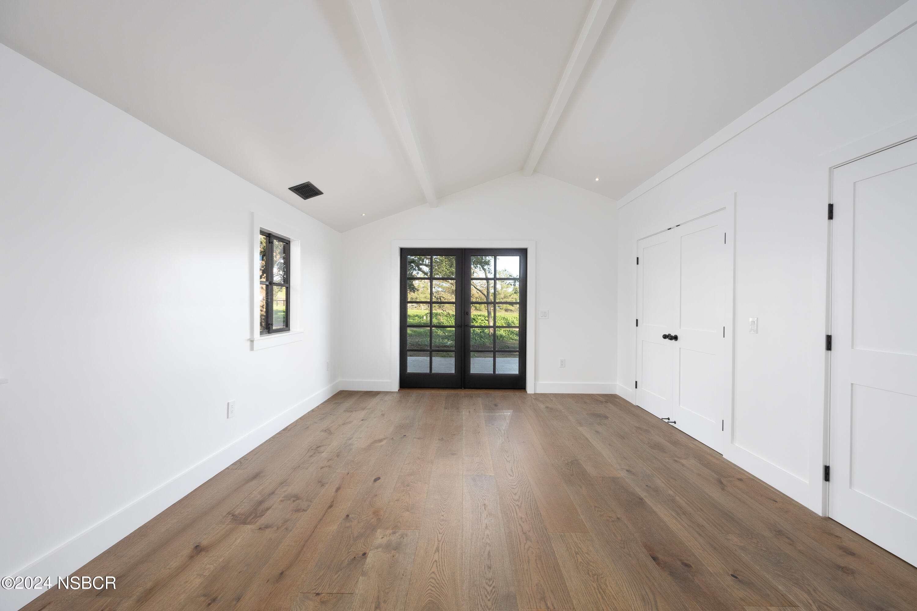 2380 North Refugio Road Santa Ynez, CA 93460 - Photo 30 of 38 a view of an empty room with wooden floor and a window