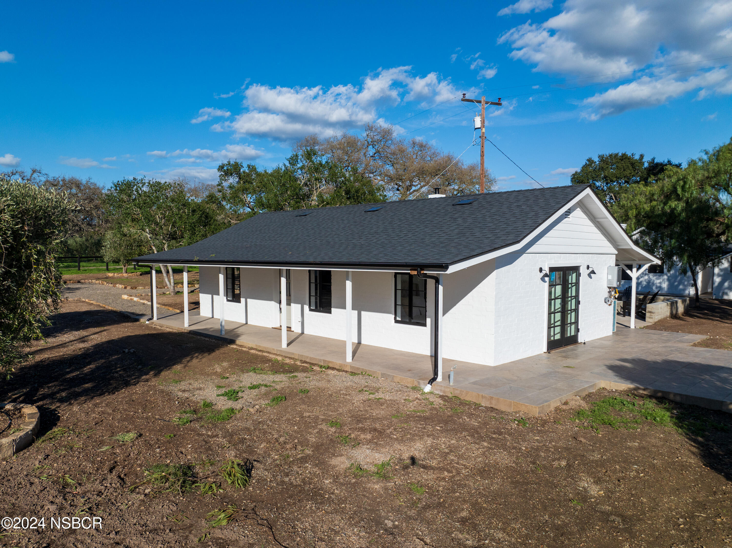 2380 North Refugio Road Santa Ynez, CA 93460 - Photo 4 of 38 a front view of a house with a yard and garage