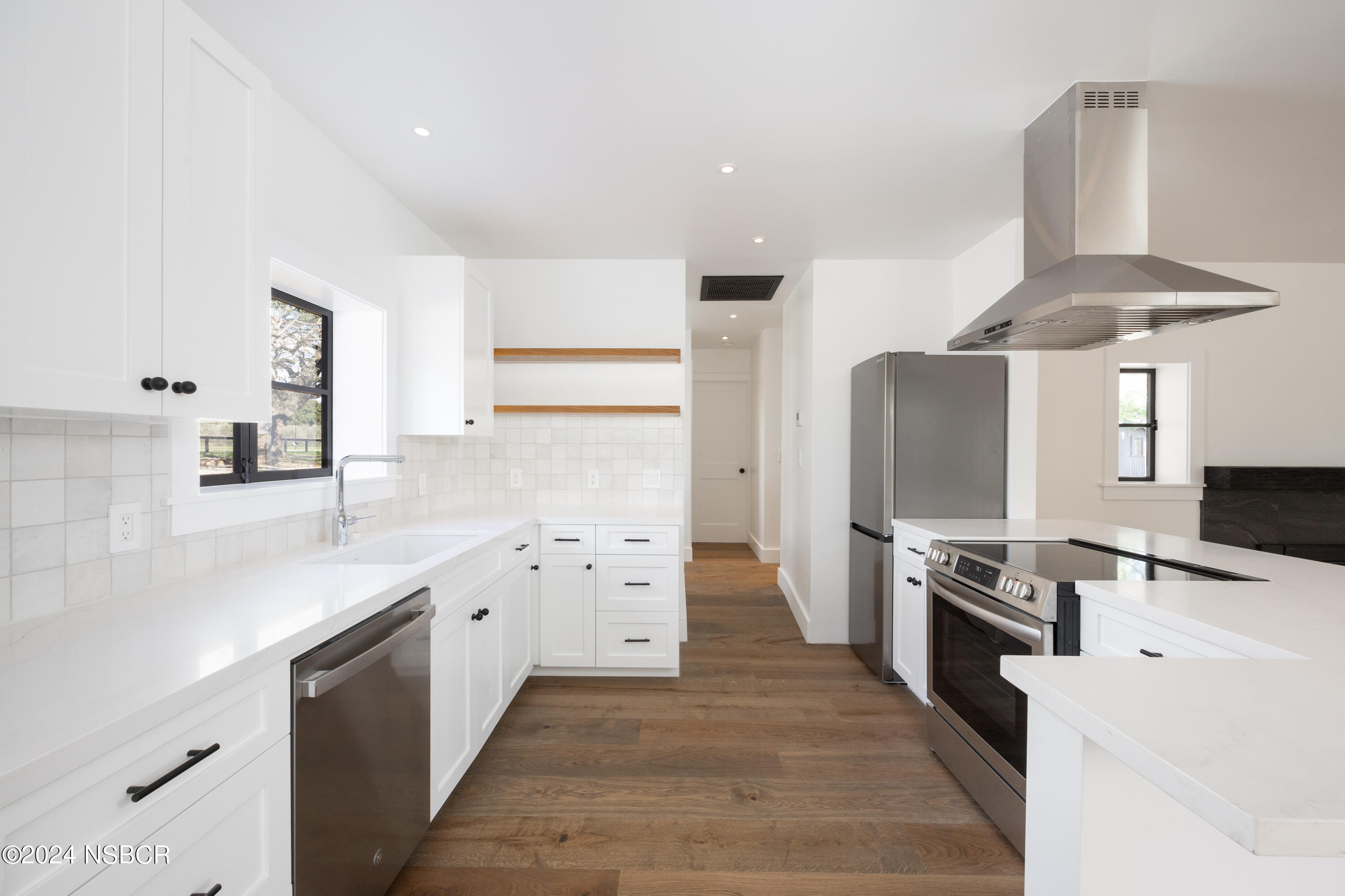2380 North Refugio Road Santa Ynez, CA 93460 - Photo 10 of 38 a kitchen with stainless steel appliances a stove refrigerator sink and cabinets