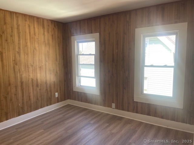 90 Waterville Street Waterbury, CT 06710 - Photo 16 of 20 a view of an empty room with wooden floor and a window