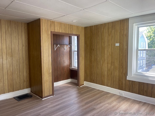 90 Waterville Street Waterbury, CT 06710 - Photo 17 of 20 an empty room with wooden floor and windows