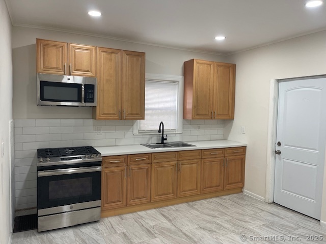 90 Waterville Street Waterbury, CT 06710 - Photo 2 of 20 a kitchen with sink a microwave and cabinets