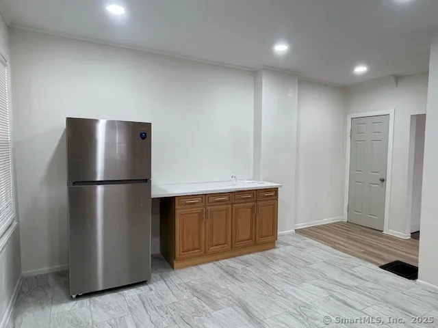 a kitchen with stainless steel appliances granite countertop a refrigerator and a sink