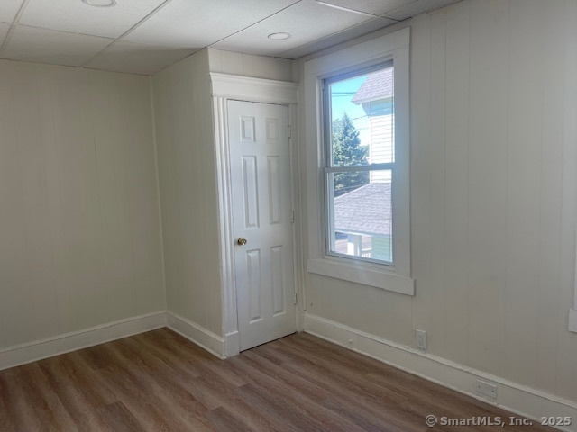 90 Waterville Street Waterbury, CT 06710 - Photo 10 of 20 an empty room with wooden floor and windows