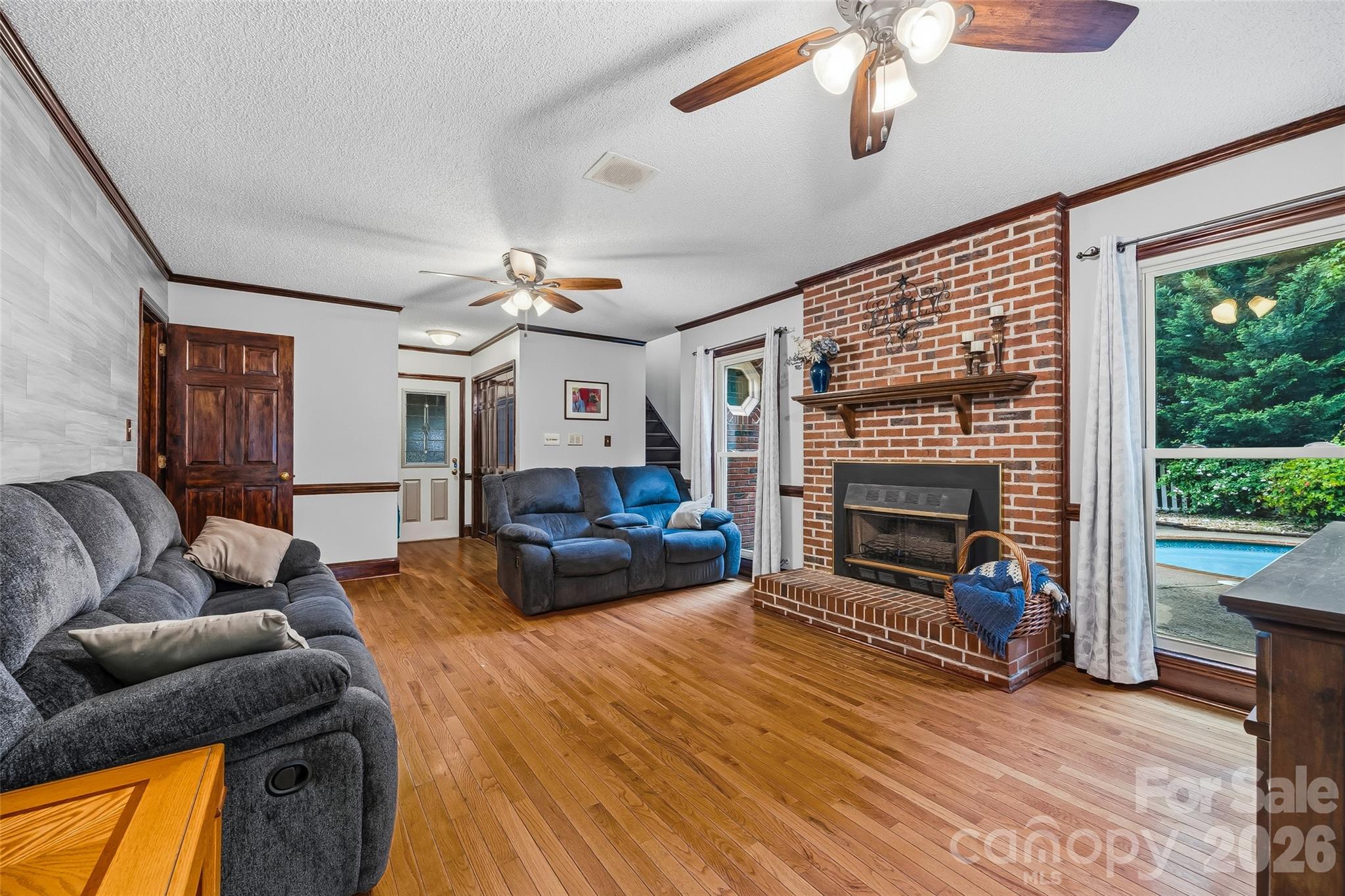 1596 Old Tara Lane Fort Mill, SC 29708 - Photo 11 of 47 a living room with furniture a flat screen tv and a fireplace