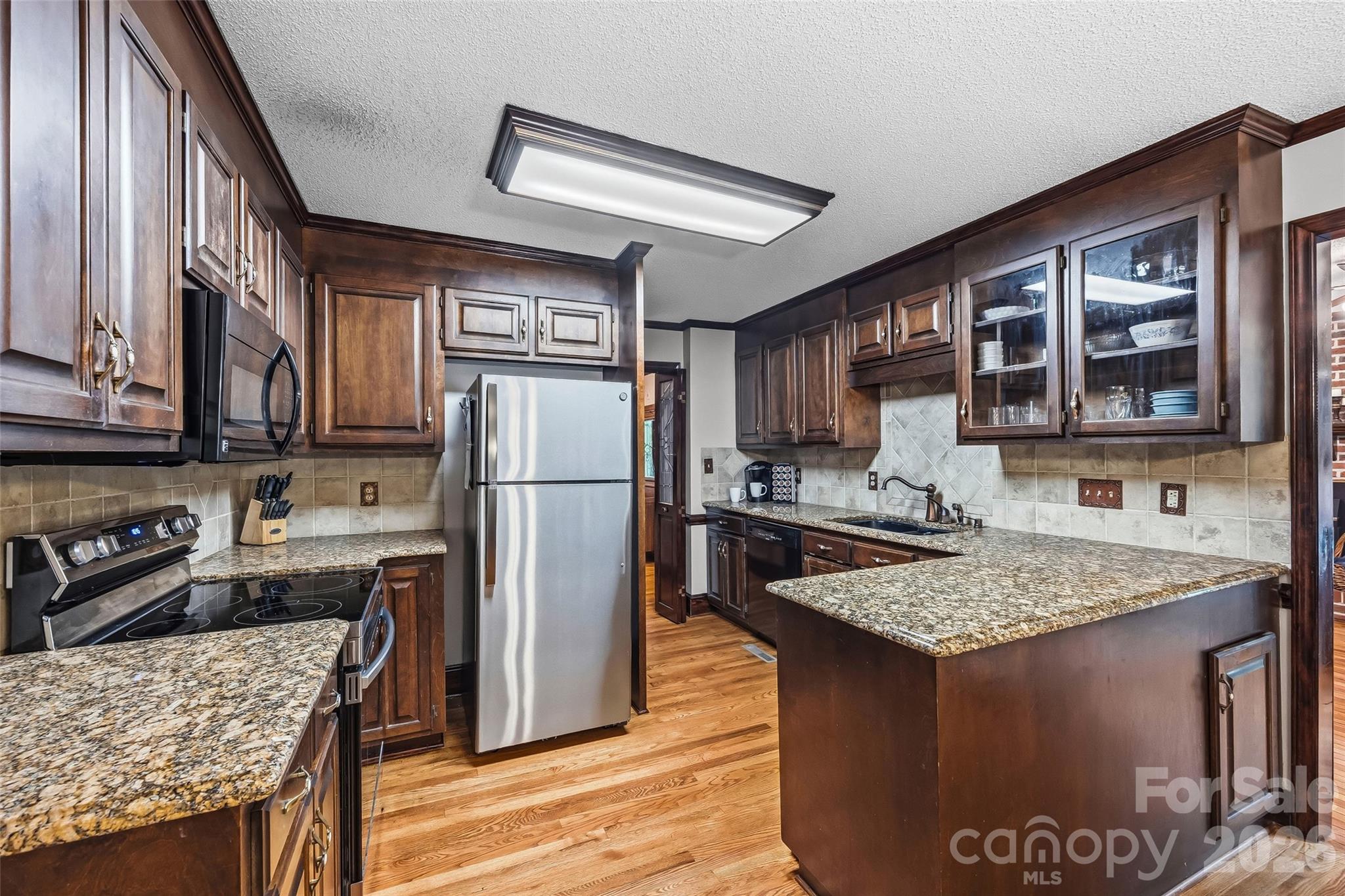 1596 Old Tara Lane Fort Mill, SC 29708 - Photo 13 of 47 a kitchen with stainless steel appliances granite countertop a sink stove and refrigerator