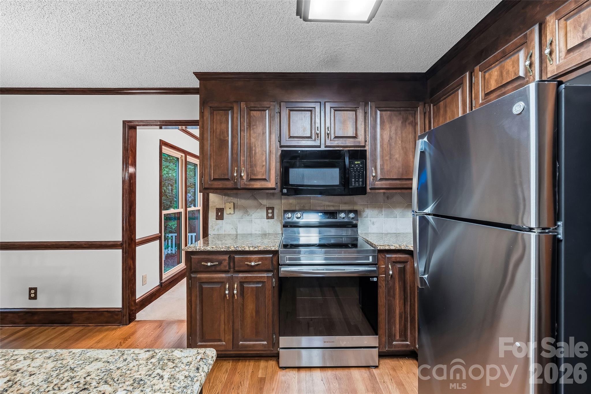 1596 Old Tara Lane Fort Mill, SC 29708 - Photo 15 of 47 a kitchen with stainless steel appliances a refrigerator stove and microwave