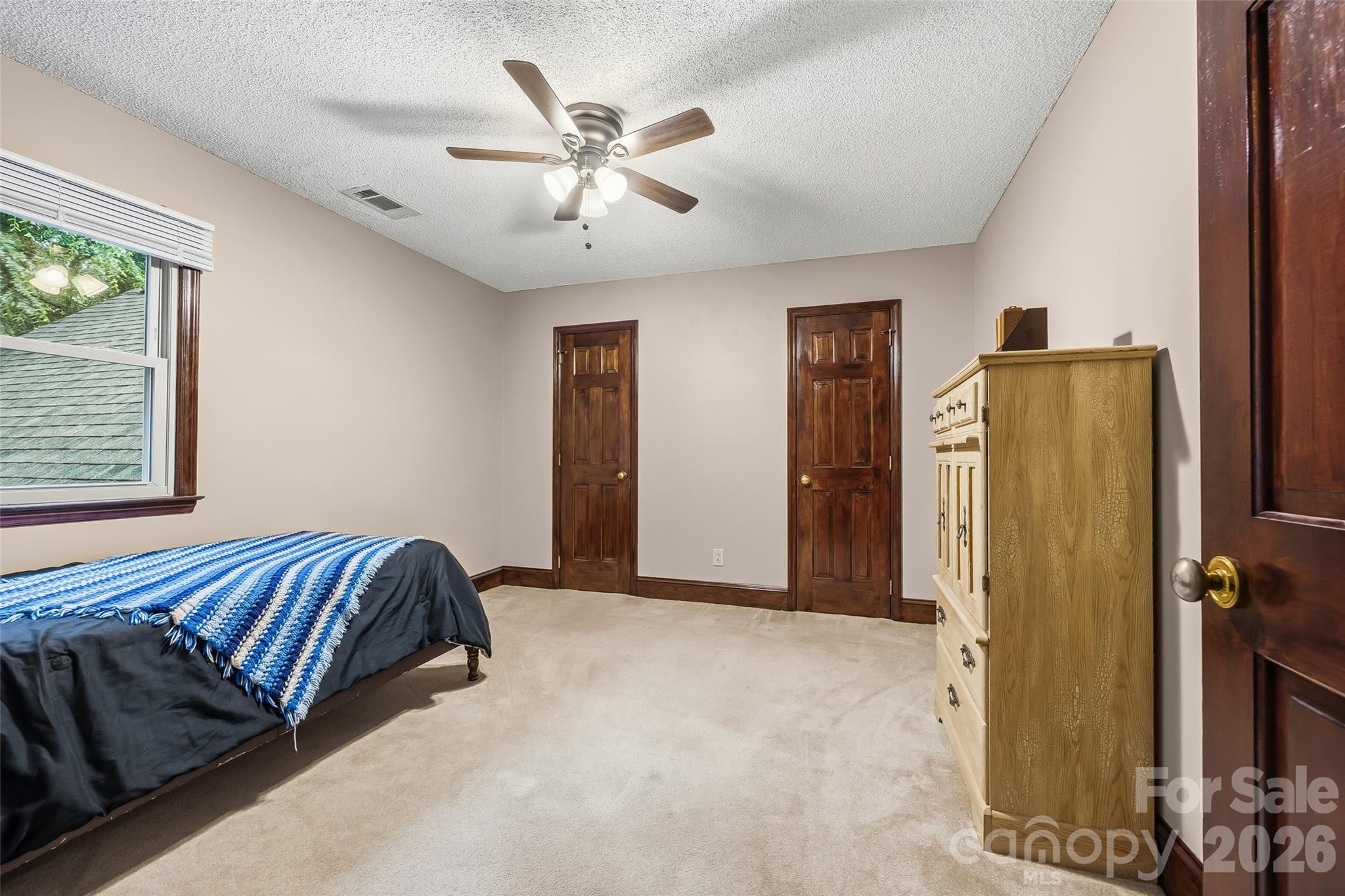1596 Old Tara Lane Fort Mill, SC 29708 - Photo 23 of 47 a bedroom with a bed and a chandelier