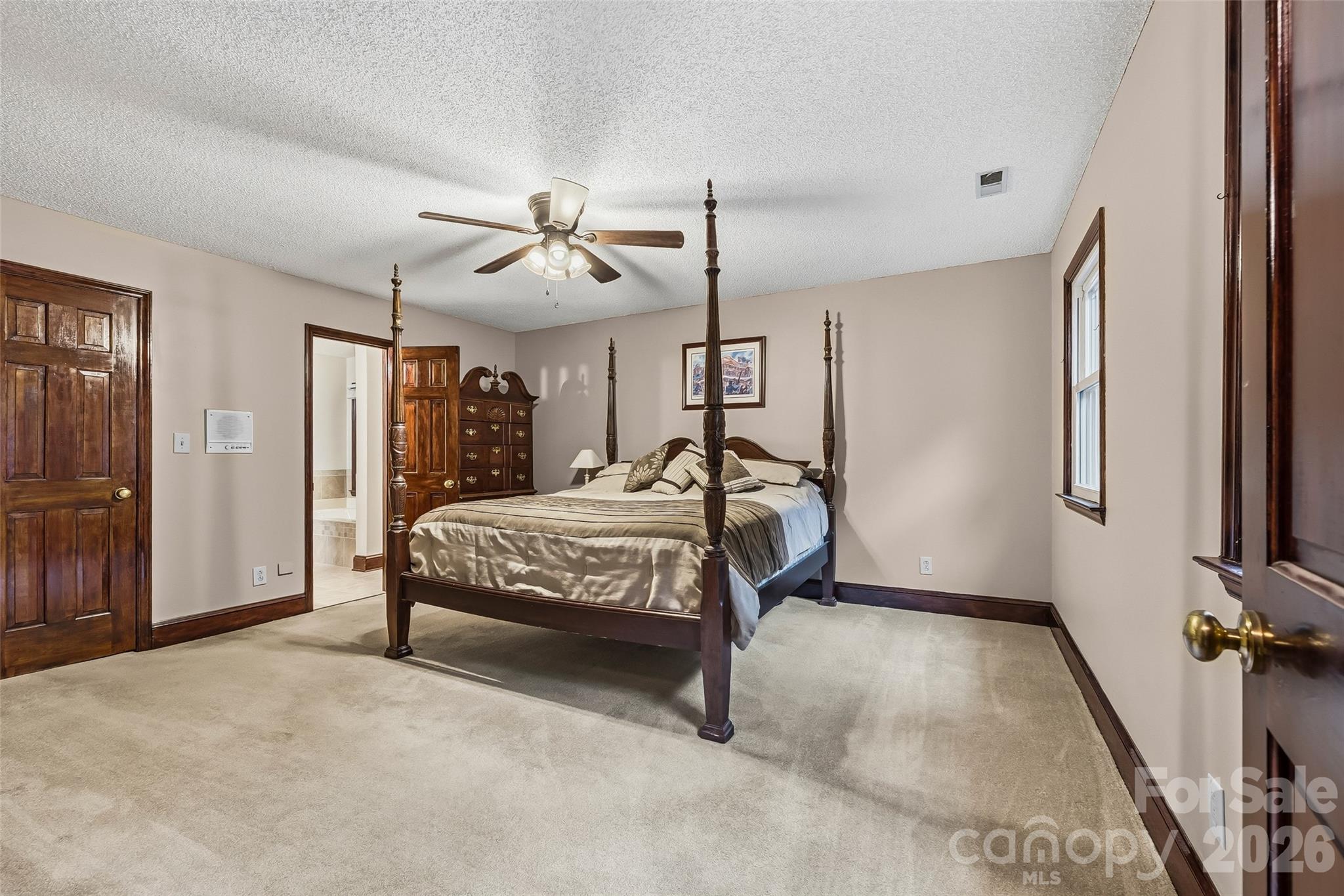 1596 Old Tara Lane Fort Mill, SC 29708 - Photo 27 of 47 a bedroom with a bed and a chandelier