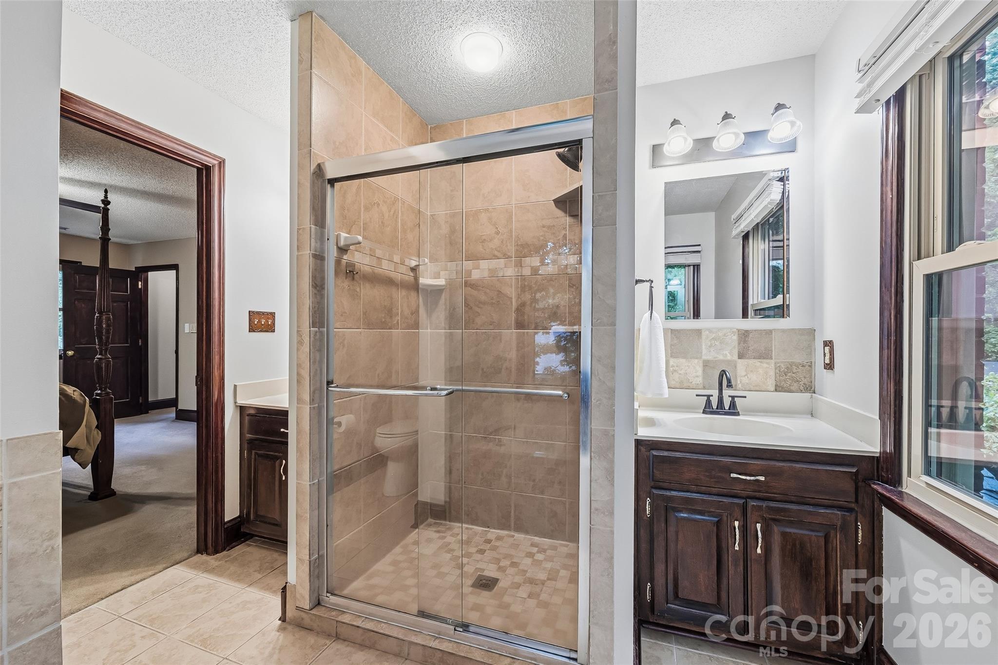 1596 Old Tara Lane Fort Mill, SC 29708 - Photo 32 of 47 a bathroom with a shower sink and mirror