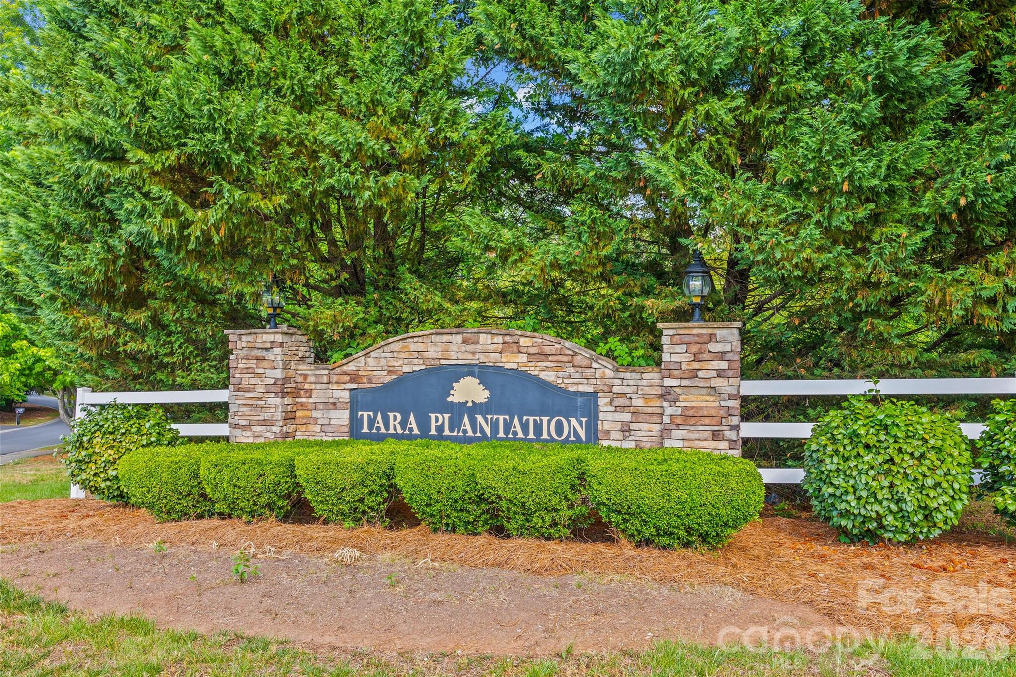1596 Old Tara Lane Fort Mill, SC 29708 - Photo 47 of 47 a view of a brick house with a yard and large trees