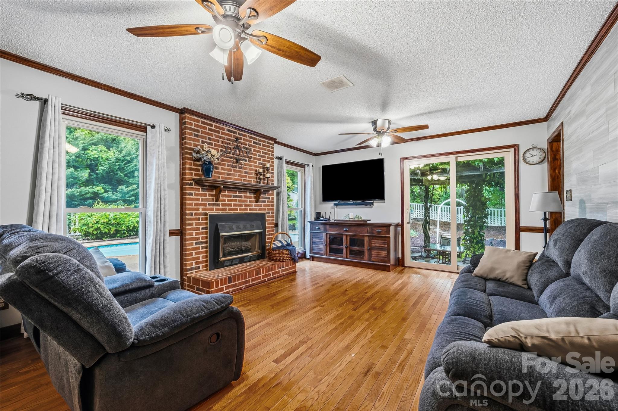 1596 Old Tara Lane Fort Mill, SC 29708 - Photo 10 of 47 a living room with furniture a fireplace and a flat screen tv