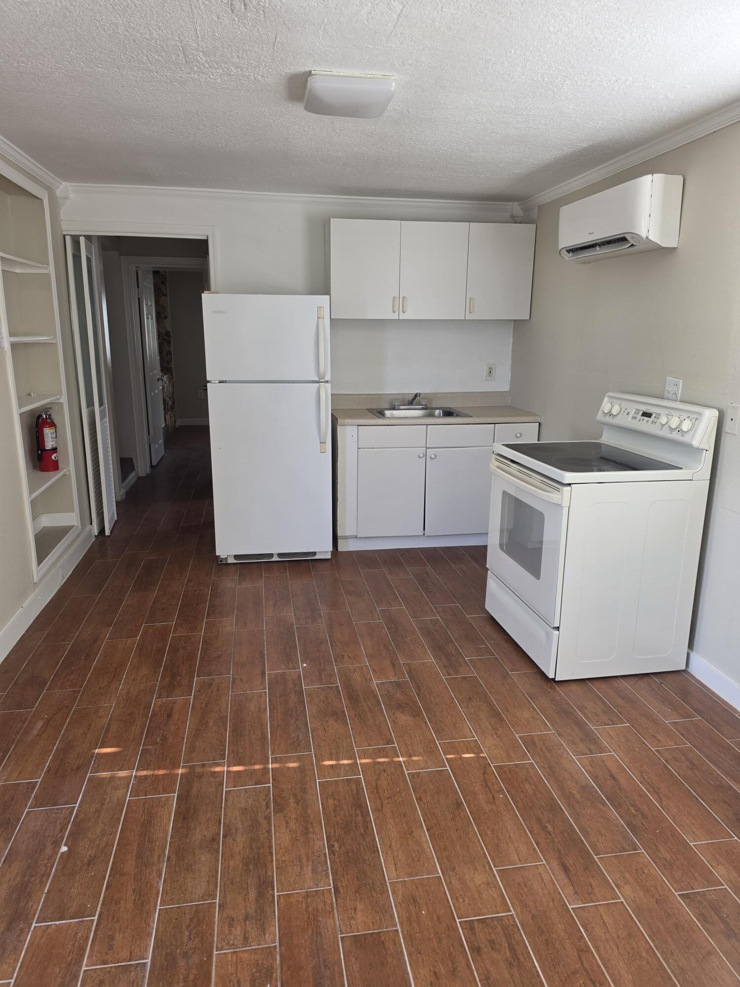5935 Taft Street, Unit 1 Hollywood, FL 33021 - Photo 2 of 9 a white cabinets and a stove sitting inside of a kitchen