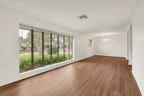 a view of an empty room with glass door