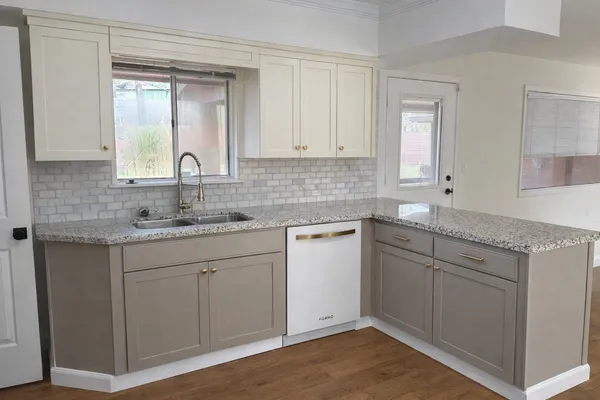 a view of a hallway with wooden floor and entryway