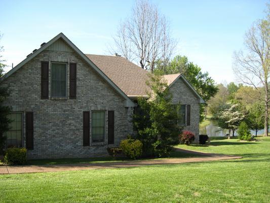 6386 Morton Road Greenbrier, TN 37073 - Photo 1 of 15 a front view of a house with a yard and garage