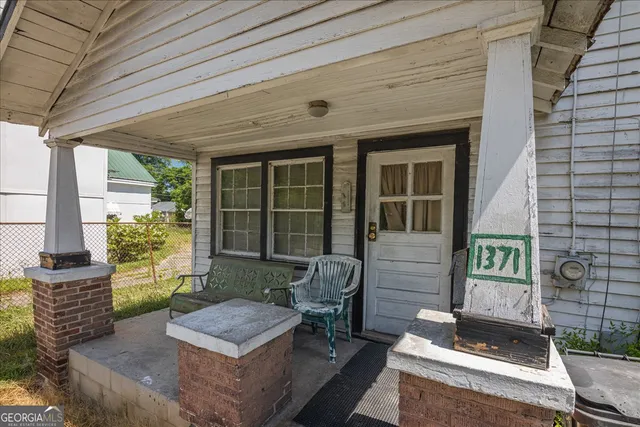 a front view of a house with outdoor seating