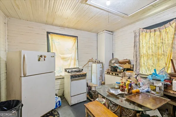 a kitchen with sink refrigerator and stove