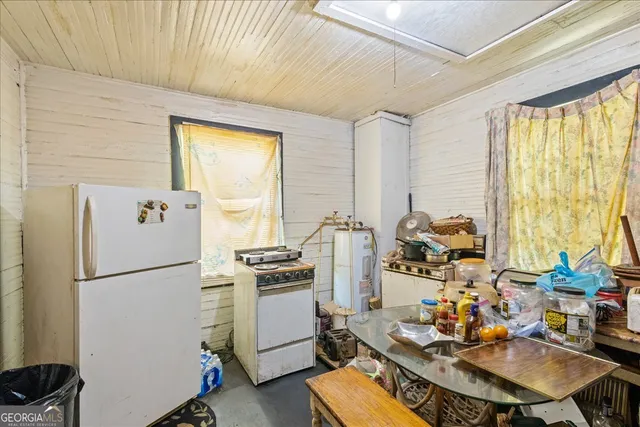a kitchen with sink refrigerator and stove