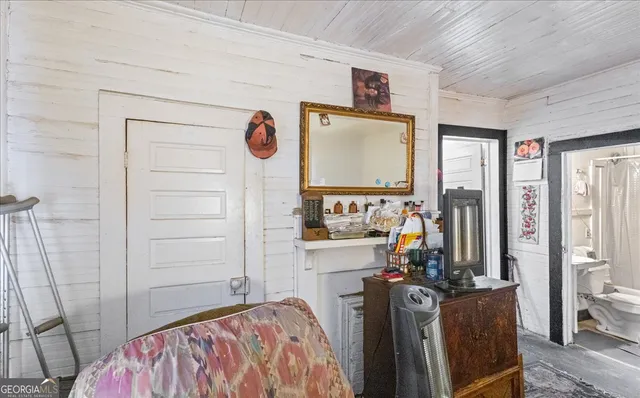 a view of a bedroom with a bed and a flat tv screen