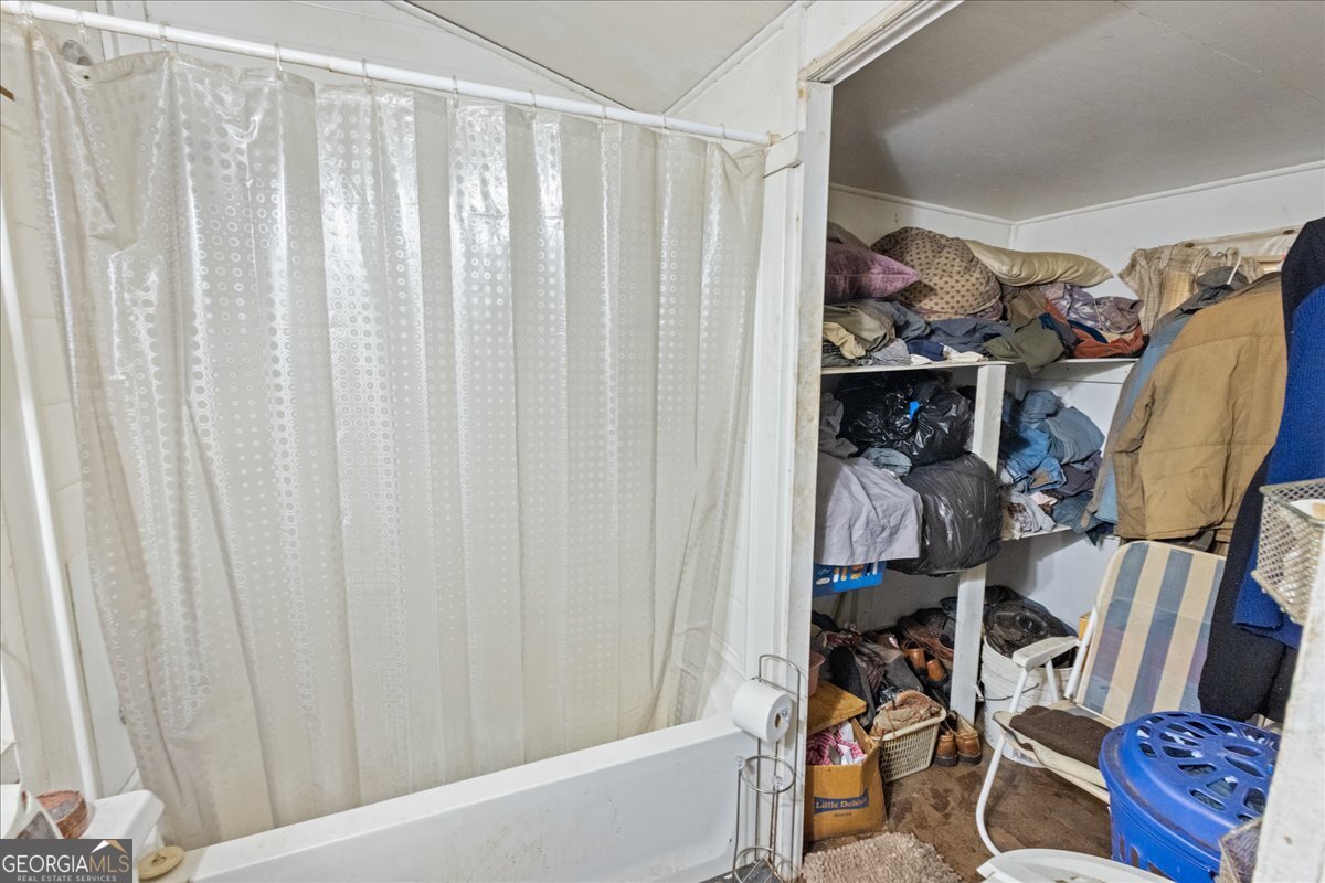1377 Wrightsboro Road Augusta, GA 30901 - Photo 26 of 49 a view of walk in closet with clothes and shoes