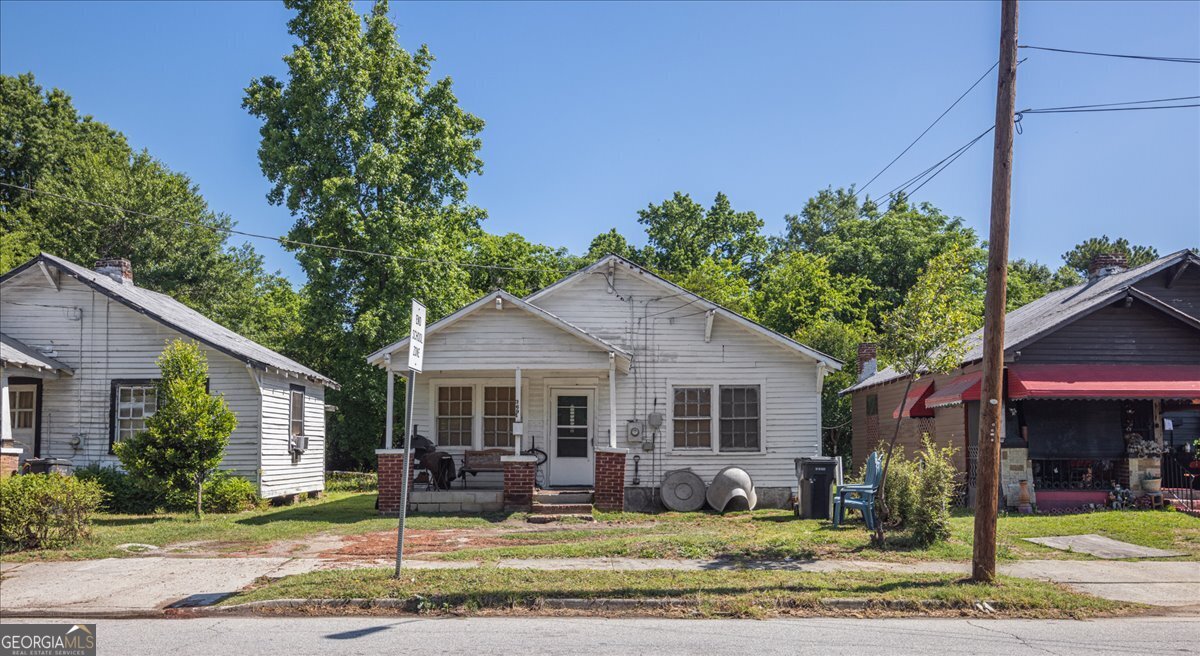1377 Wrightsboro Road Augusta, GA 30901 - Photo 27 of 49 a front view of a house with garden and porch