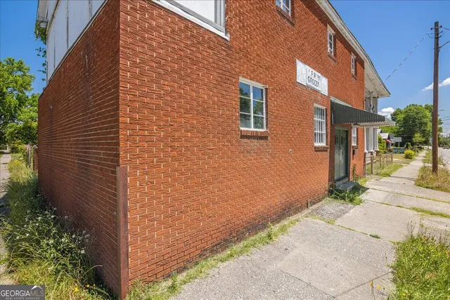 a view of a brick building with many windows