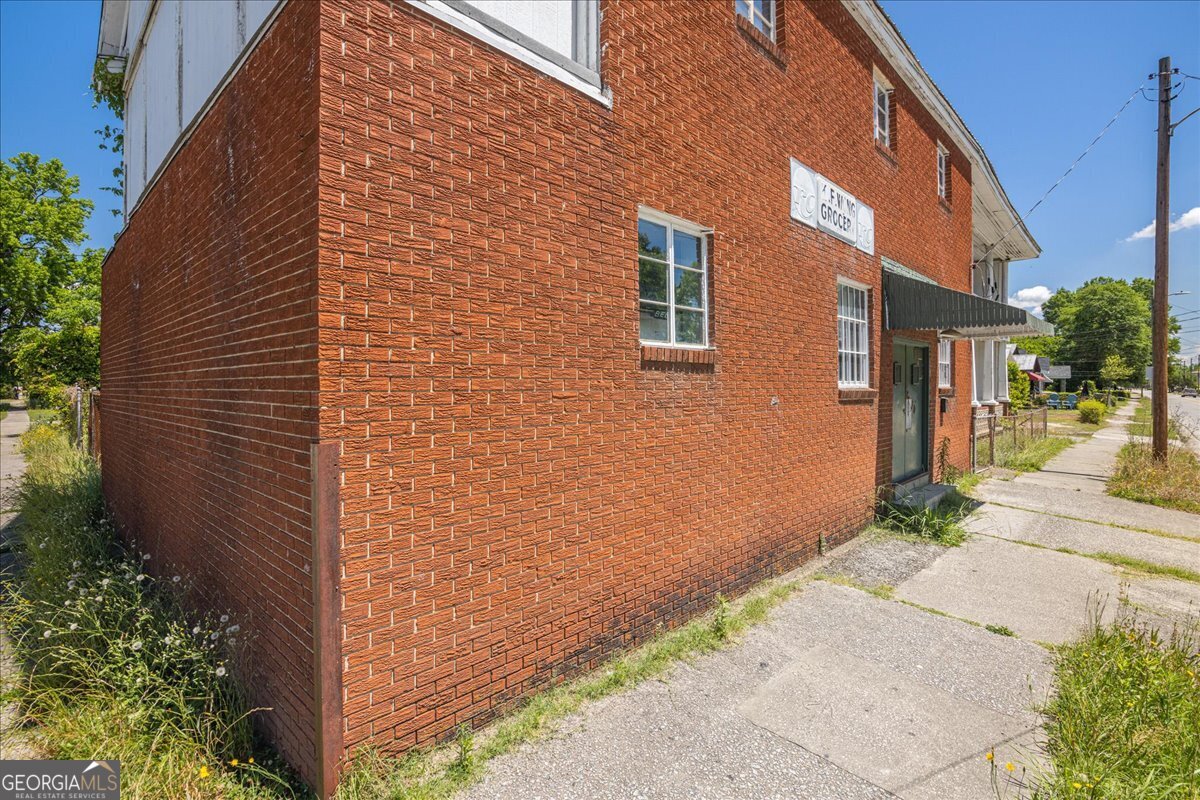 1377 Wrightsboro Road Augusta, GA 30901 - Photo 3 of 49 a view of a brick building with many windows