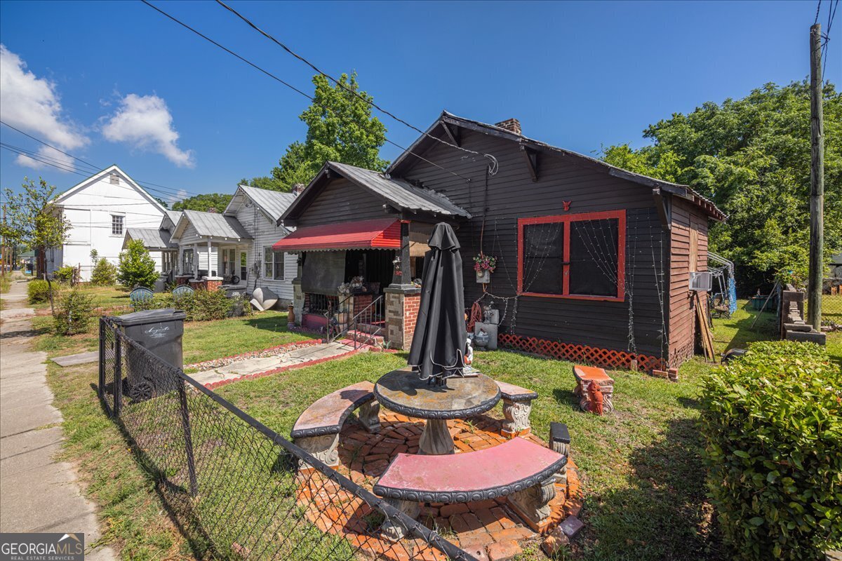 1377 Wrightsboro Road Augusta, GA 30901 - Photo 35 of 49 a patio with a table and chairs and potted plants