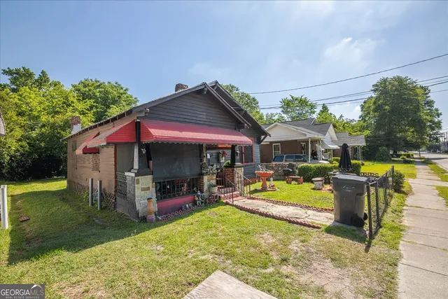 a view of a house with swimming pool and sitting area