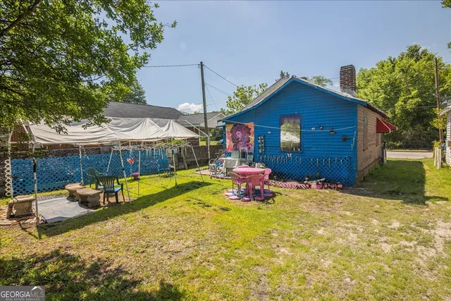 an aerial view of residential house with outdoor space and trees all around