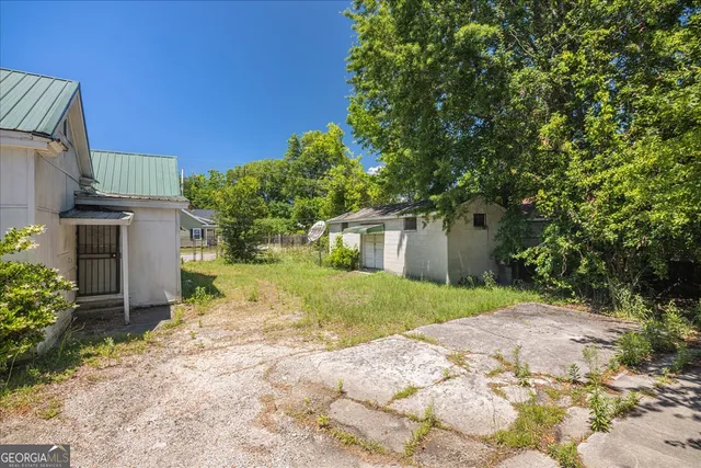 a view of a house with a yard and tree s