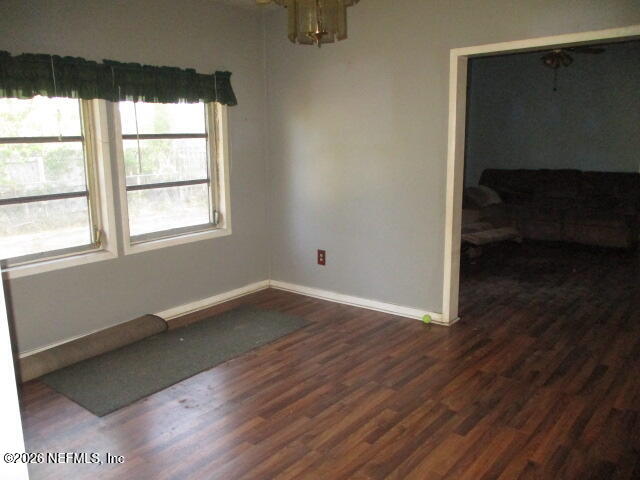 9742 Highway 301 Hampton, FL 32044 - Photo 11 of 19 a view of an empty room with wooden floor and a window