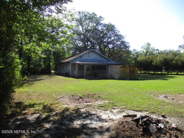 9742 Highway 301 Hampton, FL 32044 - Photo 6 of 19 a backyard of a house with lots of green space