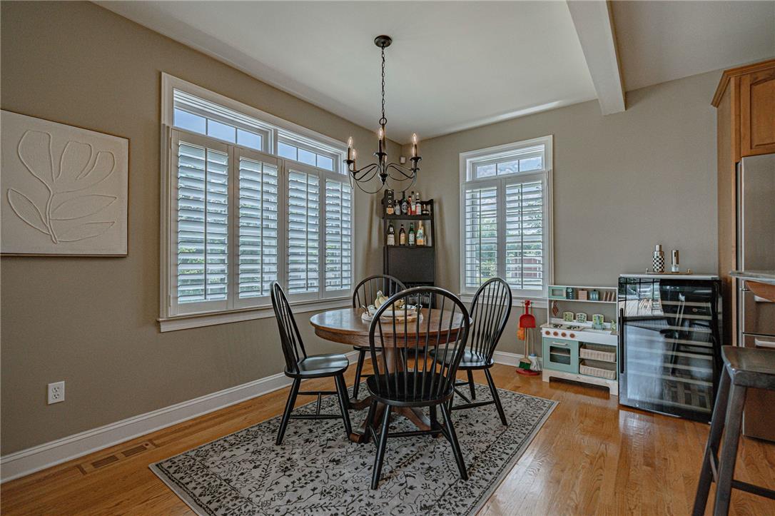 6000 Pond View Terrace Bath, PA 18014 - Photo 26 of 69 Dine in a well-lit space with charming windows and rich hardwood flooring, beneath a classic chandelier.
