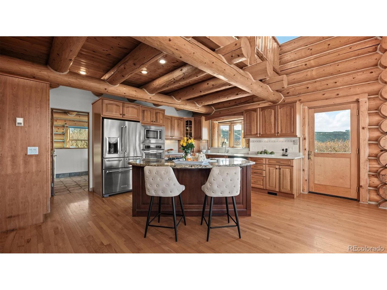 3875 F F 3/4 Road Palisade, CO 81526 - Photo 18 of 45 a open kitchen with stainless steel appliances kitchen island granite countertop a sink table and chairs