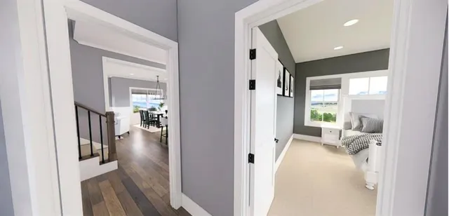 a hall way with wooden floor and a living room