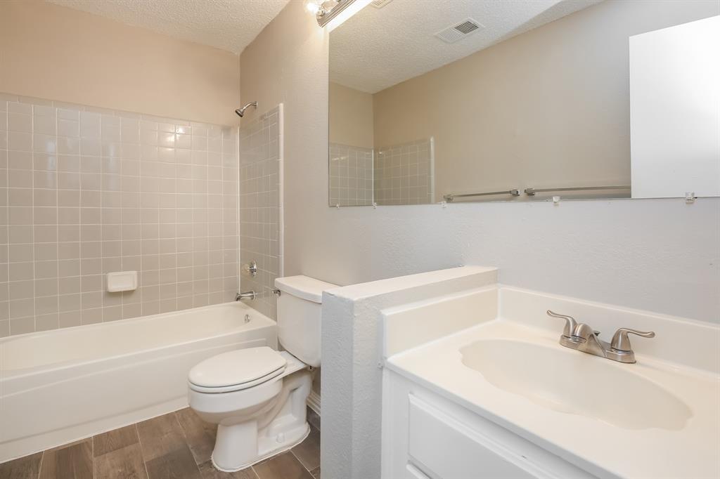 8209 Quail Glenn Court Rowlett, TX 75089 - Photo 13 of 16 a bathroom with a sink a toilet and a bathtub