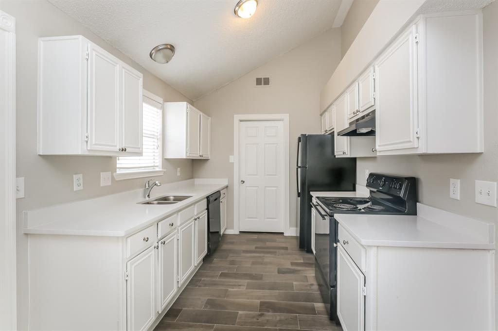 8209 Quail Glenn Court Rowlett, TX 75089 - Photo 6 of 16 a kitchen with a sink stove and refrigerator
