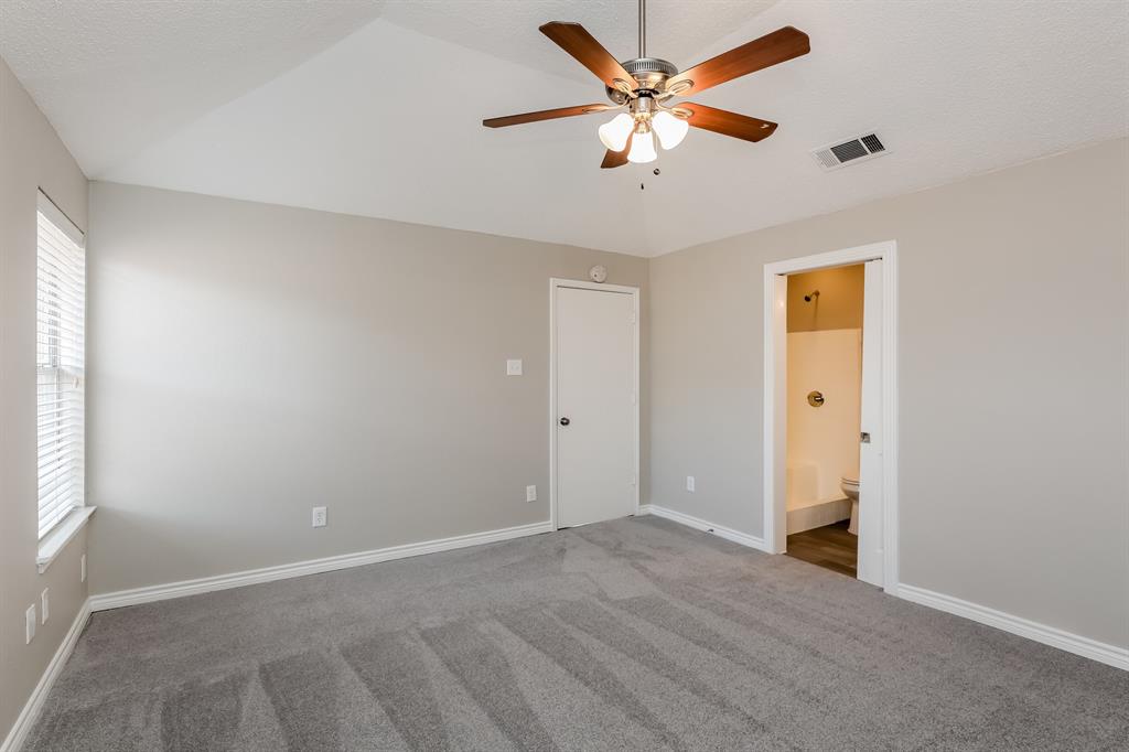 8209 Quail Glenn Court Rowlett, TX 75089 - Photo 8 of 16 an empty room with closet and a ceiling fan