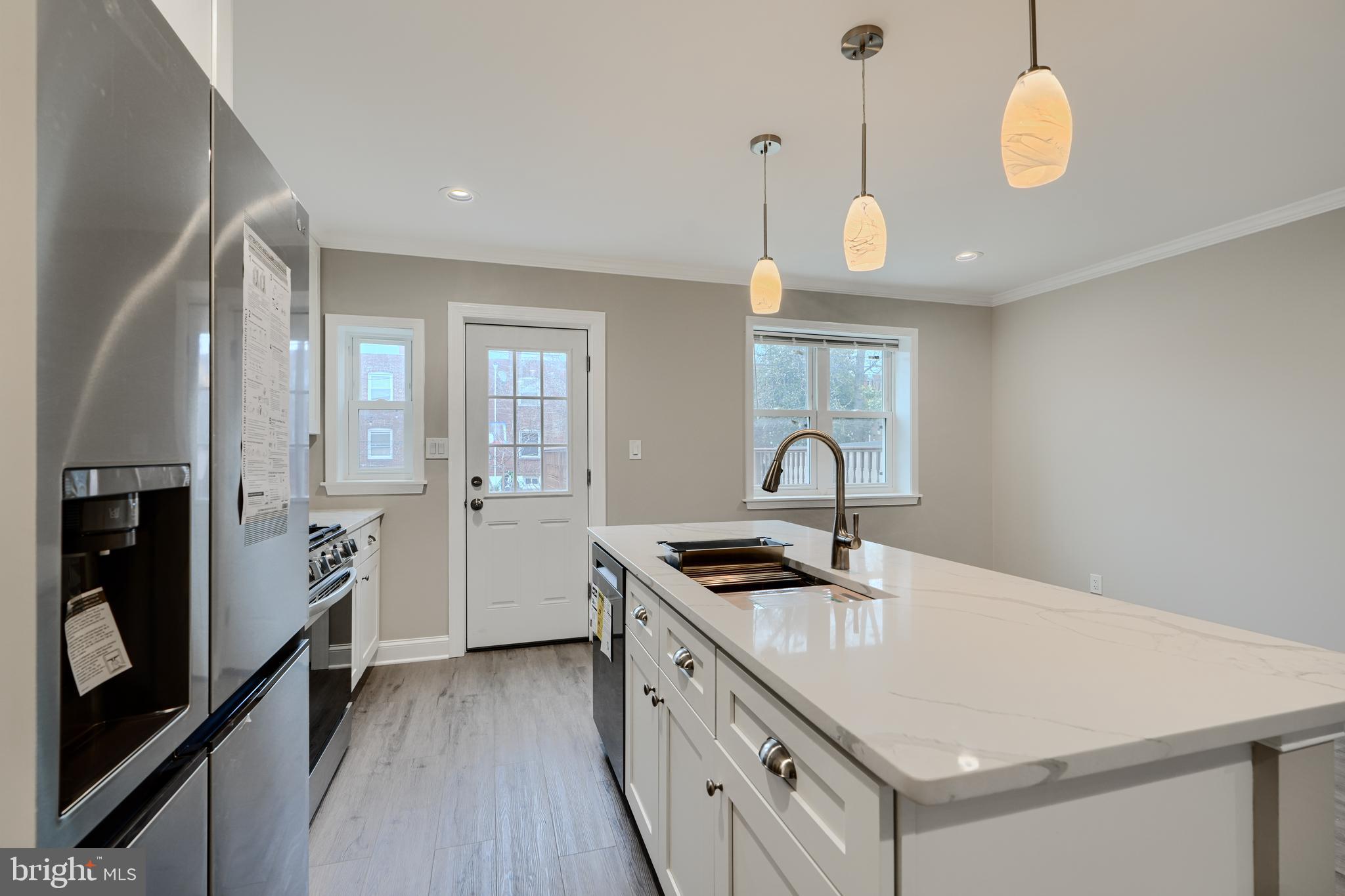 621 Ponca Street Baltimore, MD 21224 - Photo 13 of 38 a kitchen with stainless steel appliances a stove sink and cabinets